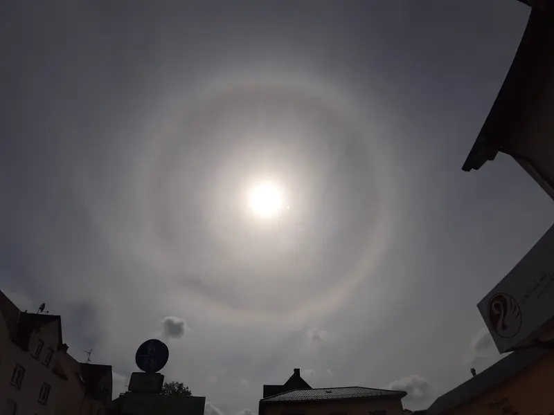 Aurinko maidonvalkoisen harson takana, ja sen ympärillä vaalea rengas.